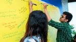 Participating team members chalking out a plan on the board