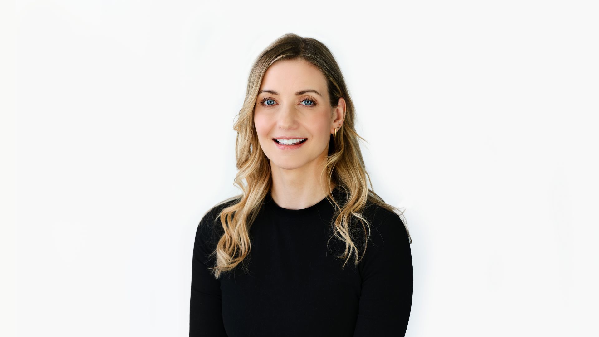 Sarah Potter, Influencer & Media Director for Unilever Personal Care, smiling. Sarah is a blonde woman in a black top.