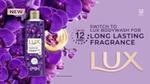 A photo of LUX Body Wash Fragrant Skin. Purple bottle surrounded by purple flowers.