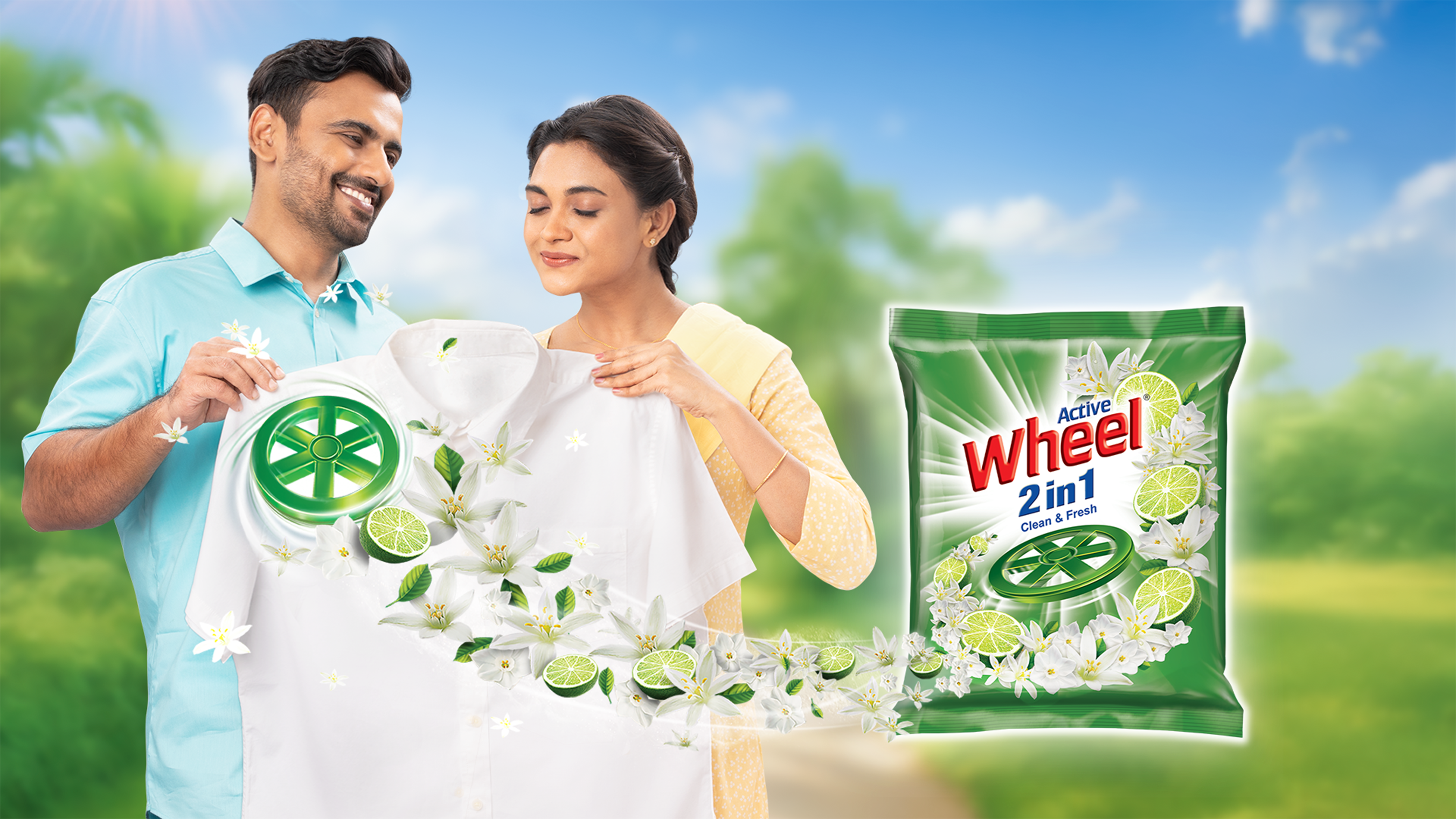 A man and a woman holding a white shirt a packet of Wheel 2in1
