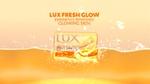 LUX Fresh Glow soap bar in a sea of tangerine freshness