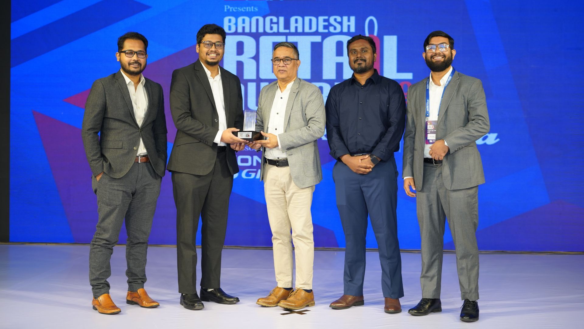 UBL Representatives accepting award on stage.